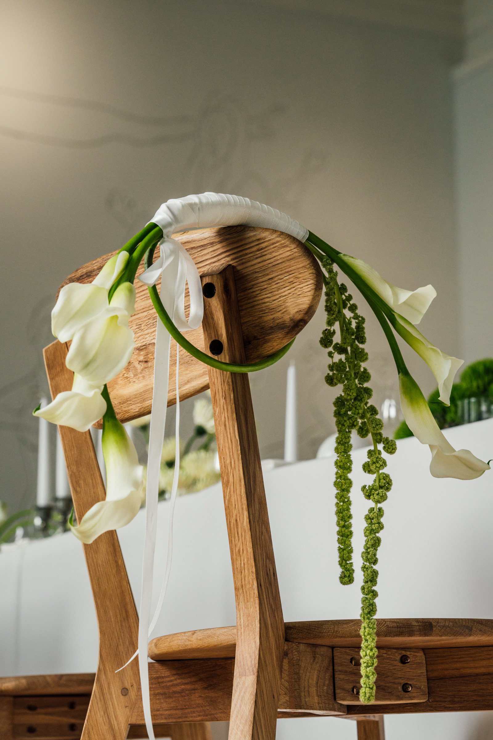 bridal bouquet on wedding reception decorated chair in vynvytis studio kaunas lithuania