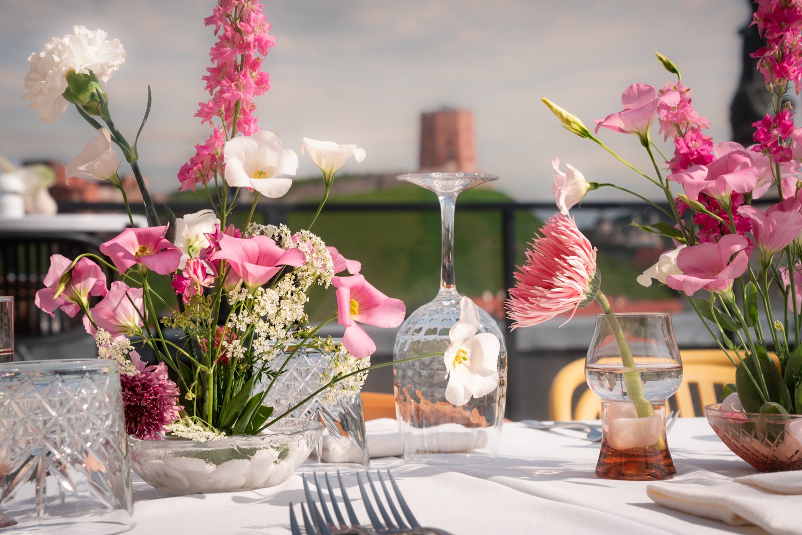 Wedding decor in vilnius oldtown building rooftop table ping flowers gedimino pilis